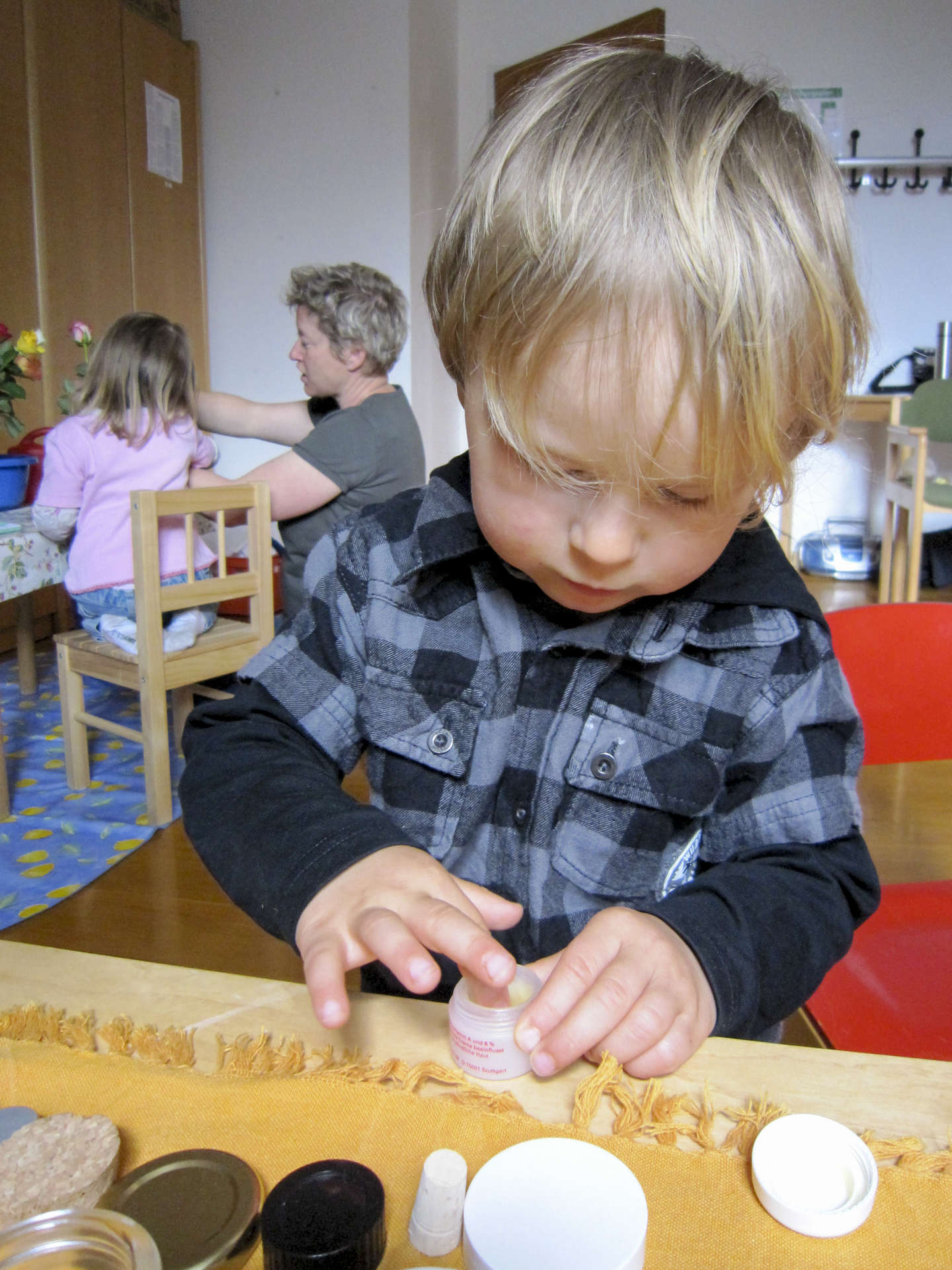 Ein kleiner Junge vertieft in eine Übung des täglichen Lebens
